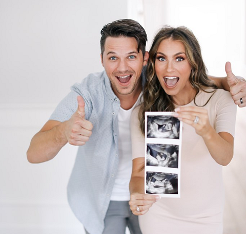 Matt and Angela shot a photo with the Ultrasound pic of their child 