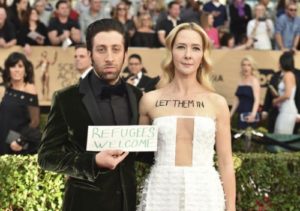 Simon Helberg and wife Jocelyn Towne at the 23rd Annual Screen Actors Guild Awards holding up Anti-Immigration ban signs.