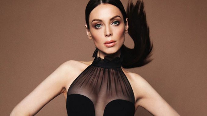 Yoanna House in a black dress during a photoshoot.