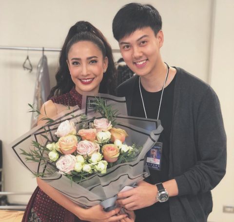 Natapohn Tameeruks with her high-school boyfriend Lhaisakul, holding a bouquet of flowers.