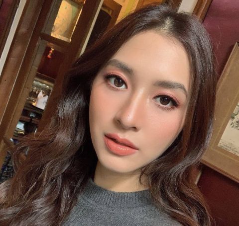 Nittha Jirayungyurn clicks a close-up selfie in a grey top.