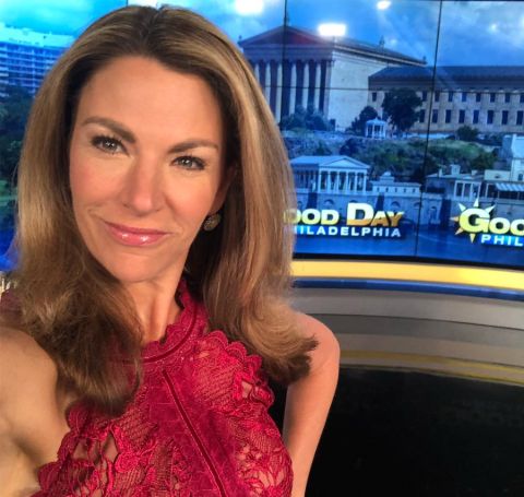 Fox 29's Karen Hepp in a red dress poses a selfie.