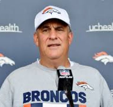 Vic Fangio in Denver Broncos' t-shirt gives an interview.