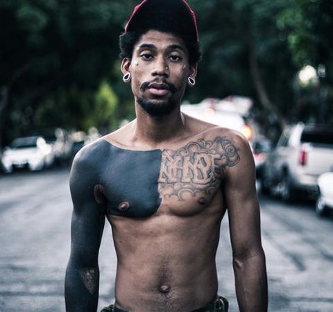 Hodgy topless poses for a photoshoot.