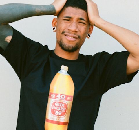 Hodgy in a black t-shirt poses for a picture.