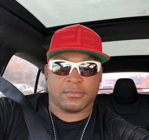 Marlon Byrd in a red cap poses for a picture in car.