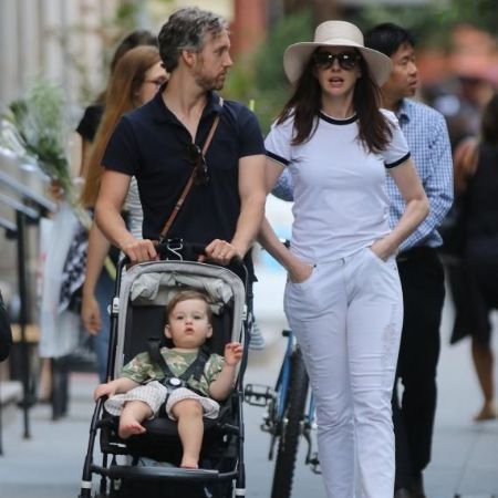 Adam with his wife, Anne Hathaway, and their son
