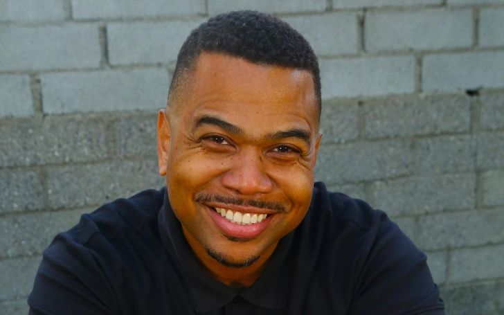 Omar Gooding wearing a black t-shirt and posing for a photo.