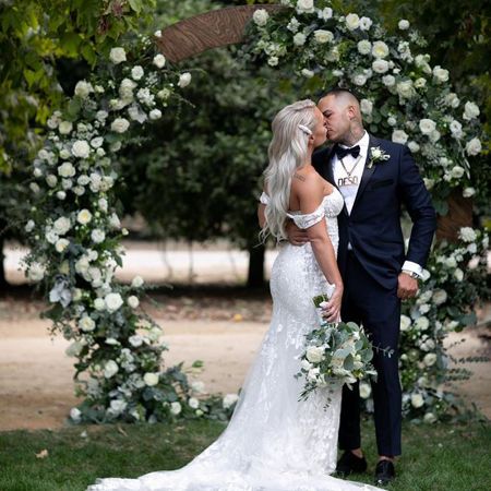  Derek Deso kissing his wife, Sophia Turner, on their wedding day.