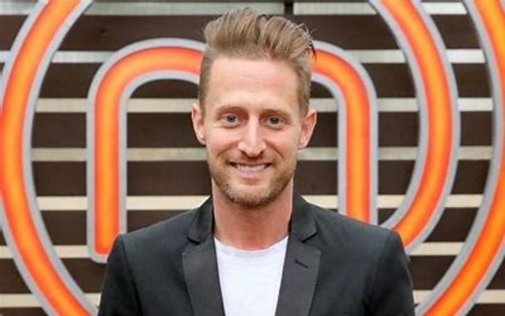 Michael Voltaggio dressed up and smiling for a photo.